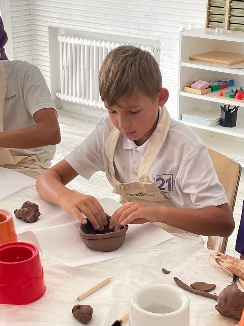 Child making clay pot